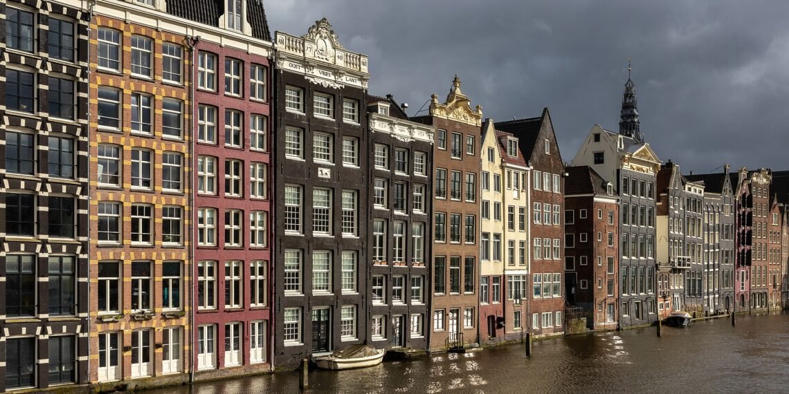 Canal houses on the Damrak in Amsterdam
