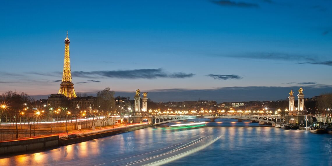Eiffel Tower and Pont Alexandre III over the Seine in Paris at night
