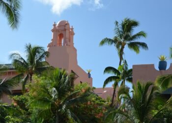 The pink Royal Hawaiian hotel framed by palm trees in Waikiki, Honolulu