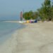 Whitehouse Beach at the Sandals resort now called Sandals South Coast, Jamaica, with palm trees and beach loungers