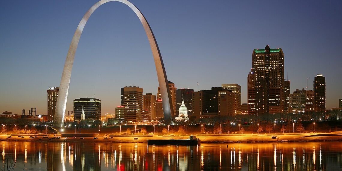 St. Louis skyline at night on the Mississippi River, with the Gateway Arch and the Old Courthouse
